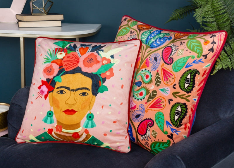 A selection of dopamine decor, including a vibrant floral cushion, interesting textures and a novelty flamingo plushie.