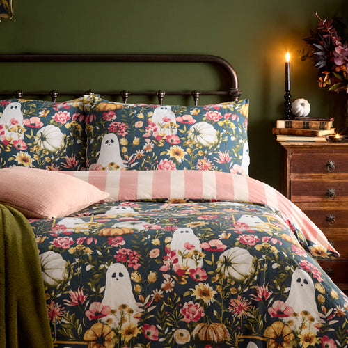 Halloween bedding featuring floral ghosts, pumpkins and a pink reversible stripe