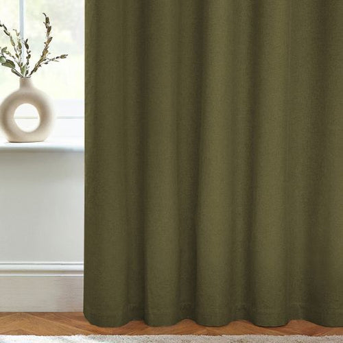 A zoomed in image of a pair of olive green black out curtains for the living room