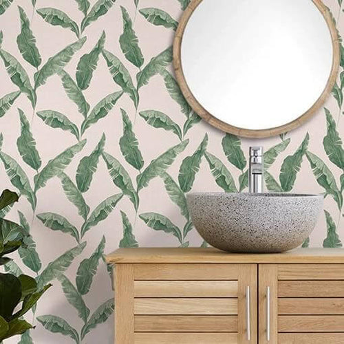 Bathroom wallpaper with a leafy plantain design, hung in a modern bathroom with a stone wash basin.