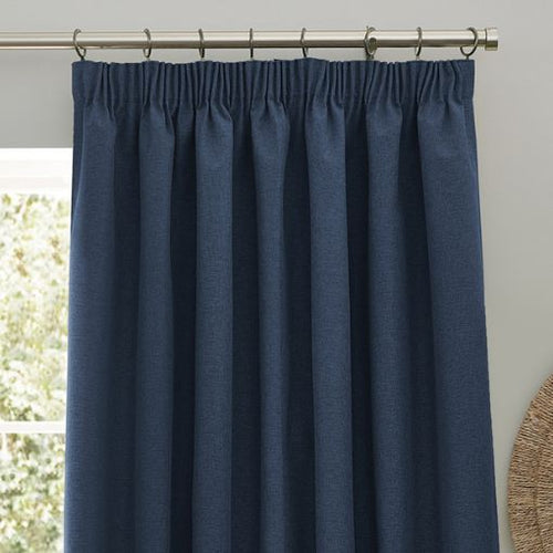 Pencil pleat curtain headers on a silver pole, the pencil pleat curtains are a dark navy blue colour