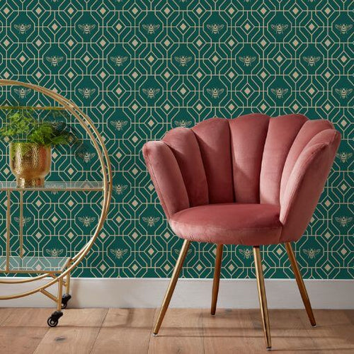 Geometric wallpaper with a green and gold honeycomb design, hung in a living room behind a chair and other furniture.