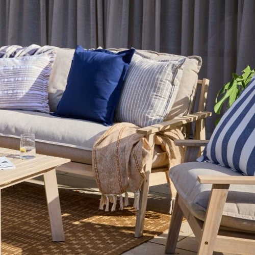 A collection of striped cushions in dark blue and beige with white stripes